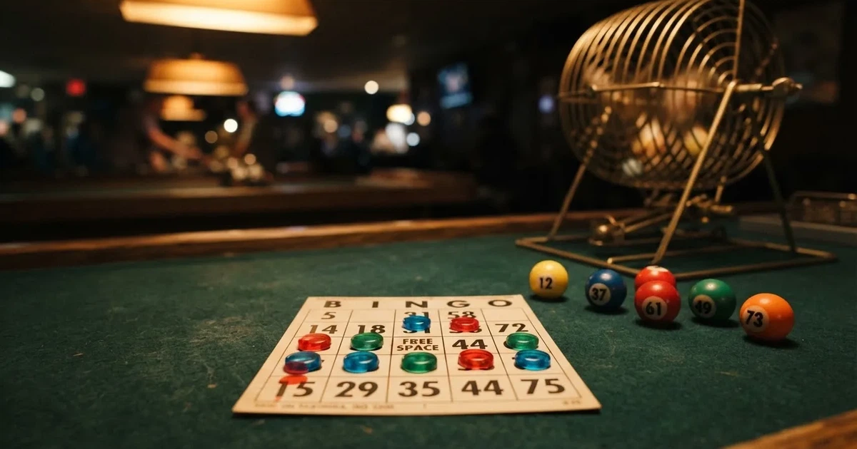 Karta do bingo z odznaczonymi liczbami obok wylosowanych kulek na stole w kasynie online
